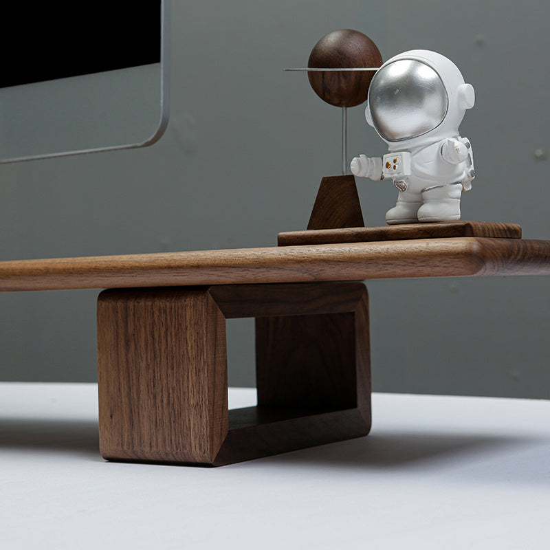 Spaceman figure on a wooden desk with a modern office background