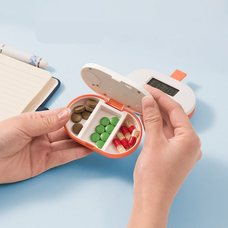 Hand holding a pill organizer with compartments filled with different colored pills on a light blue background.