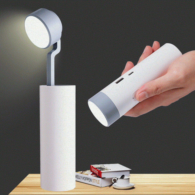 White portable lamp with a hand holding its compact version on a dark background