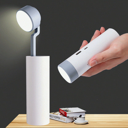 White portable lamp with a hand holding its compact version on a dark background