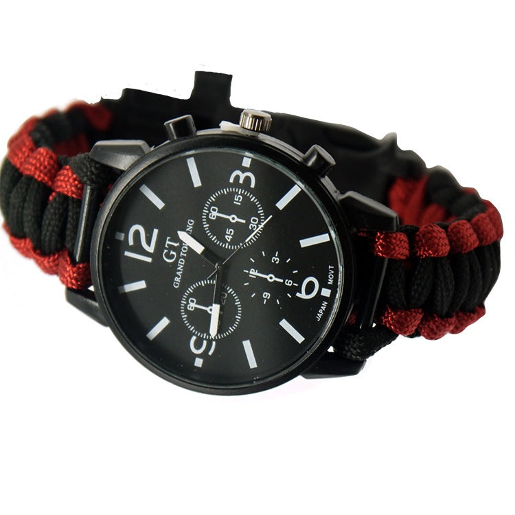 Black and red watch with a paracord strap on a white background