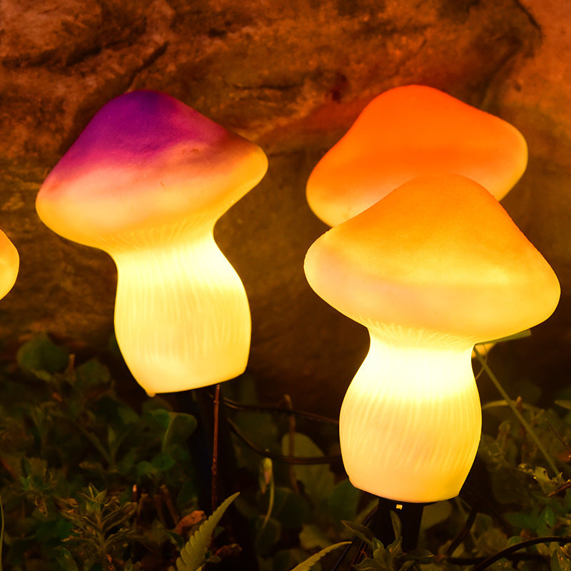Two mushroom-shaped lights glowing in a natural setting with rocks and plants.
