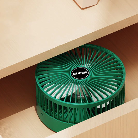 Green portable fan on a wooden surface