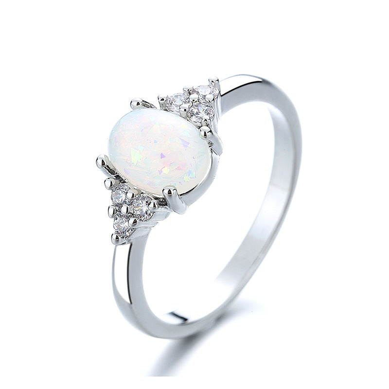 Silver ring with a white opal stone on a white background