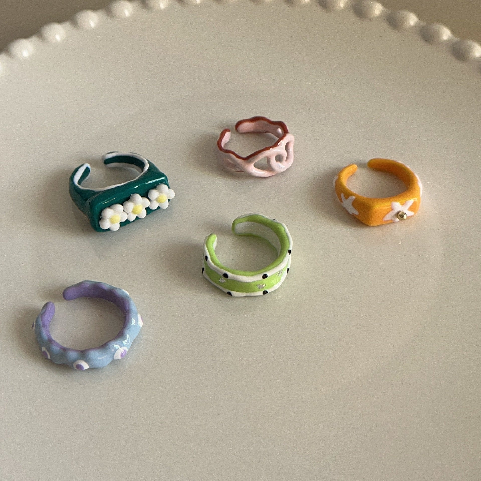 Set of colorful ceramic rings on a light gray surface