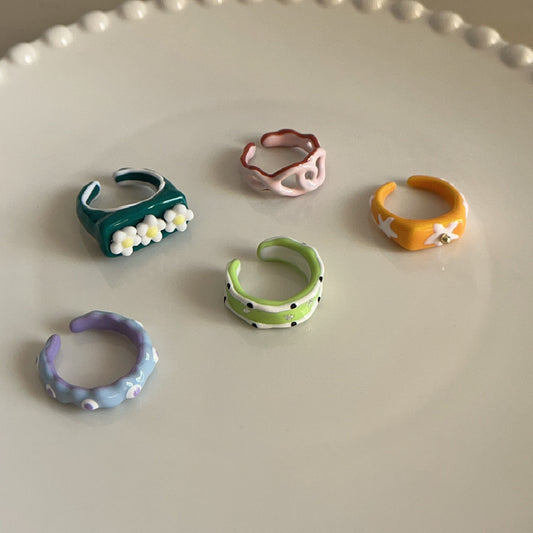 Set of colorful ceramic rings on a light gray surface