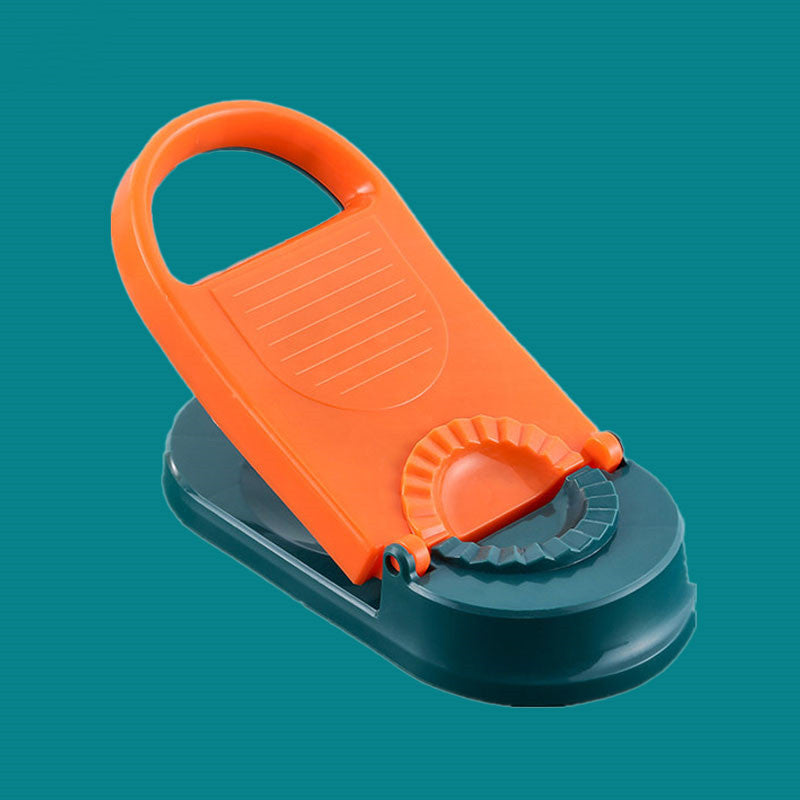 Orange and black vegetable chopper on a teal background