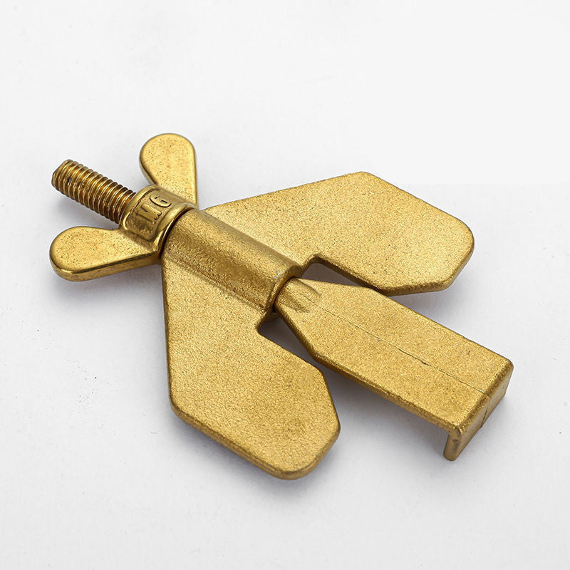 Gold-colored metal propeller-like object on a white background