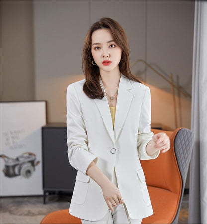 Woman wearing a white blazer in an indoor setting