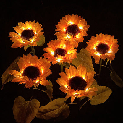 Set of illuminated sunflower lights on a dark background