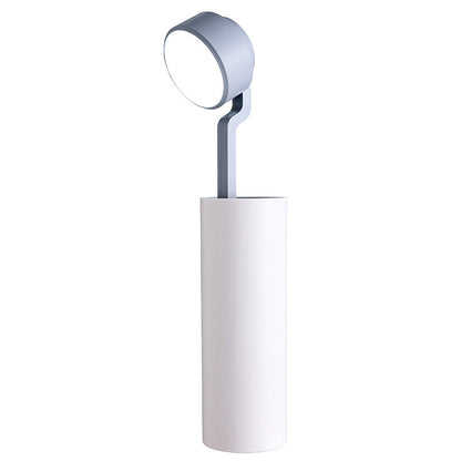Modern floor lamp with a cylindrical base and round adjustable head on a white background