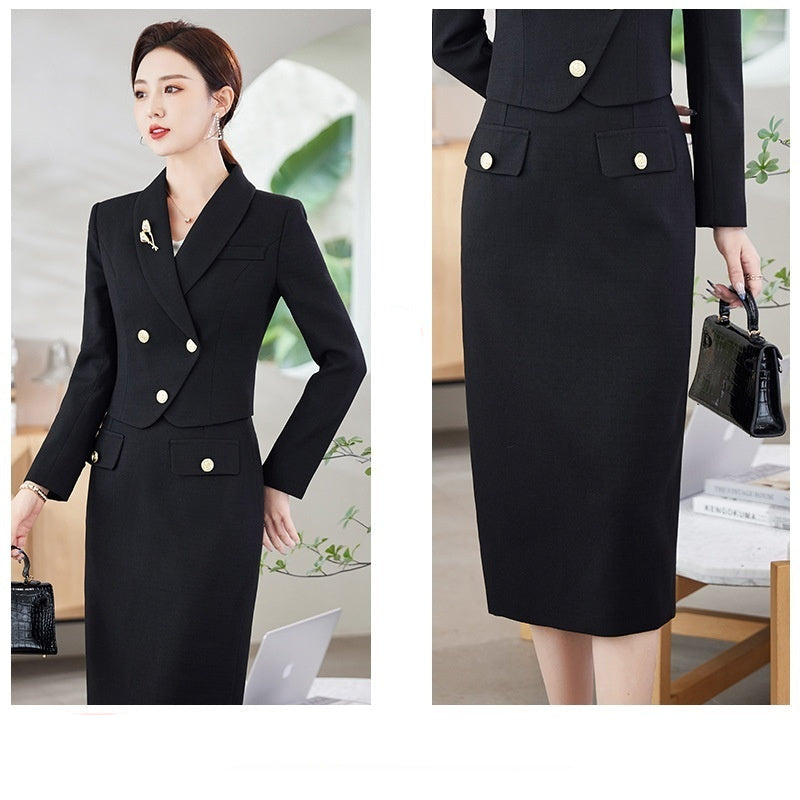 A woman in a white leisure formal suit with a blazer and a skirt, featuring long sleeves and gold buttons, standing outdoors.