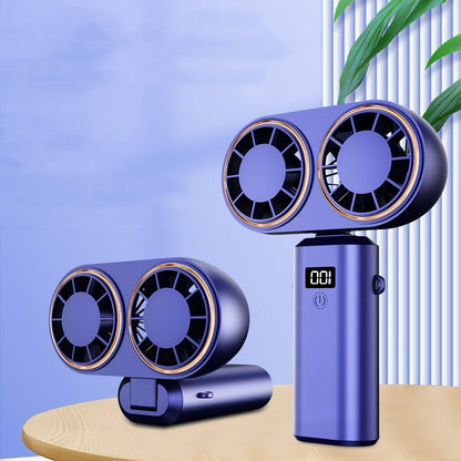 Purple handheld fan with dual fans on a wooden surface against a light blue background