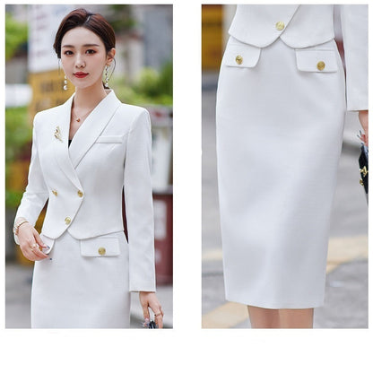 A woman in a white leisure formal suit with a blazer and a skirt, featuring long sleeves and gold buttons, standing outdoors.