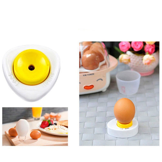 Egg piercer with a yellow top and white base, shown in use on an egg.