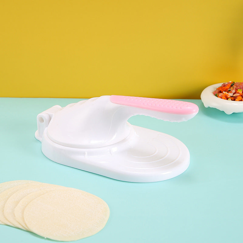 White and pink kitchen glove on a light blue surface with yellow wall in the background