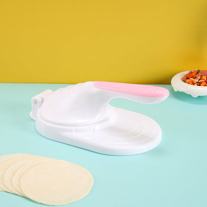 White and pink kitchen glove on a light blue surface with yellow wall in the background