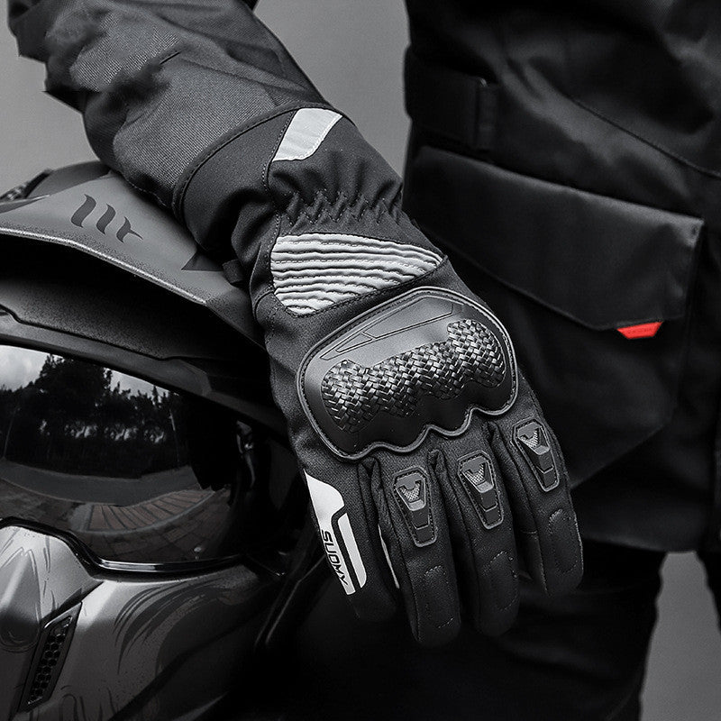 Black motorcycle glove with textured palm design on a blurred background