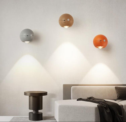 Modern wall lights in a bedroom setting with text about human induction magnetic night light.