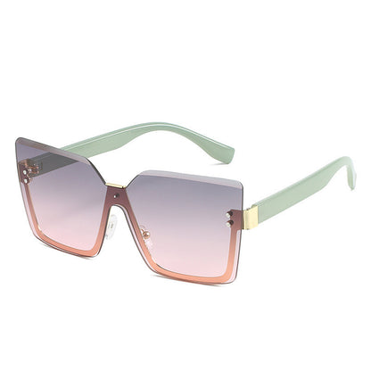 Sunglasses with gradient lenses and light green frame on a white background