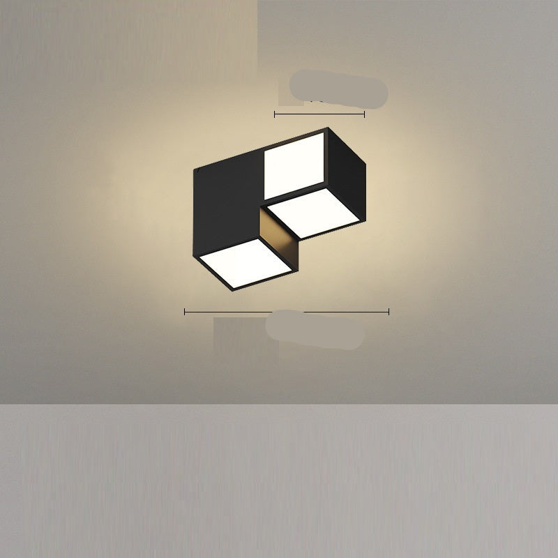 A modern black ceiling-mounted pendant light with multiple square-shaped灯heads hanging over a dining table in a contemporary room setting.