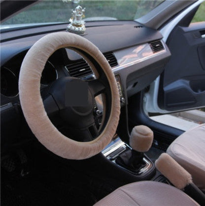 Car interior with beige steering wheel cover and seat covers.