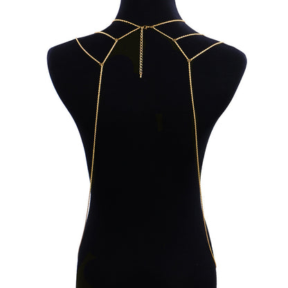 Gold chain body harness on a black mannequin