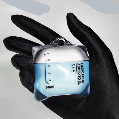 AirPods case designed like a medical container with measurement markings, held in a black glove.