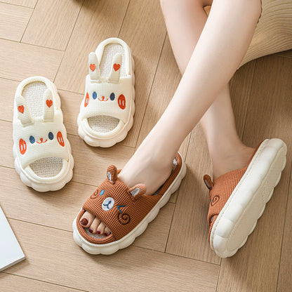 Children's sandals with cartoon designs on a wooden floor