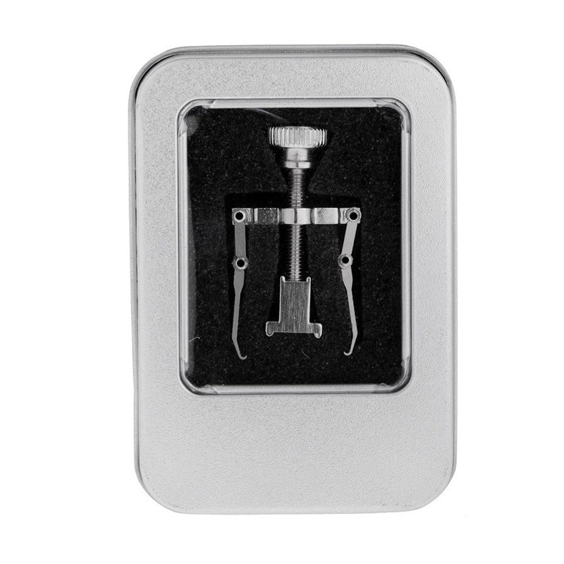 Set of metal tools in a silver box on a white background