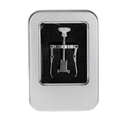 Set of metal tools in a silver box on a white background