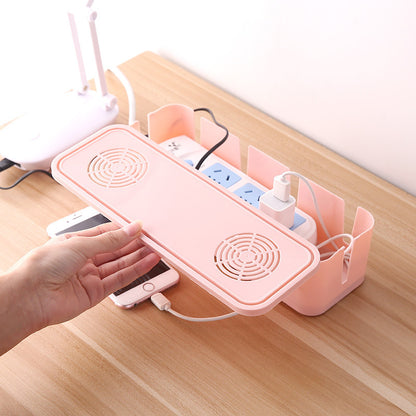 Pink desk organizer with multiple compartments on a wooden surface.