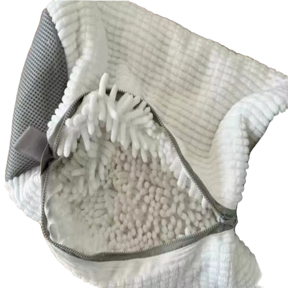 A shoe being washed in a yellow laundry bag with a grey zipper, placed in a washing machine.