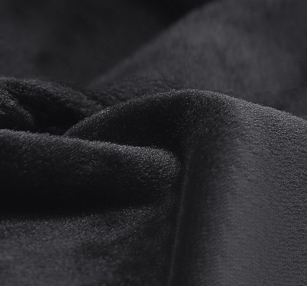 Close-up of textured black fabric with folds
