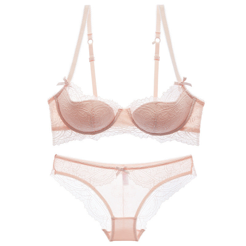 Pink lace bra and panties set on a white background