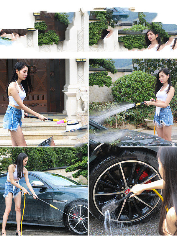 Woman washing a car with a hose and sponge, surrounded by greenery.