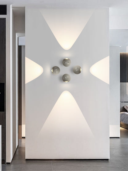 Modern interior design with geometric wall lights and a minimalistic approach.