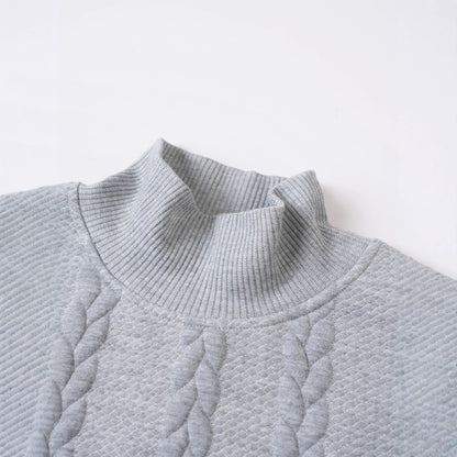 Close-up of a textured gray sweater on a light gray background