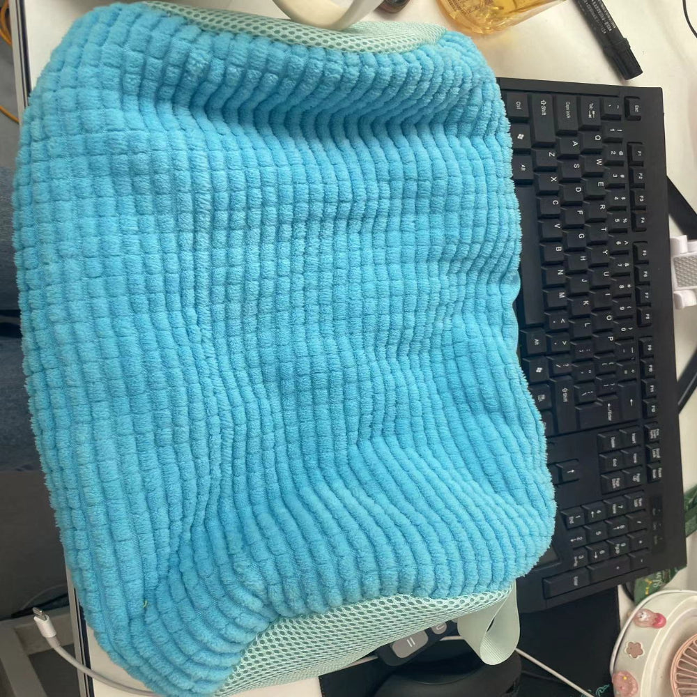Blue textured towel draped over a chair with a black keyboard in the background