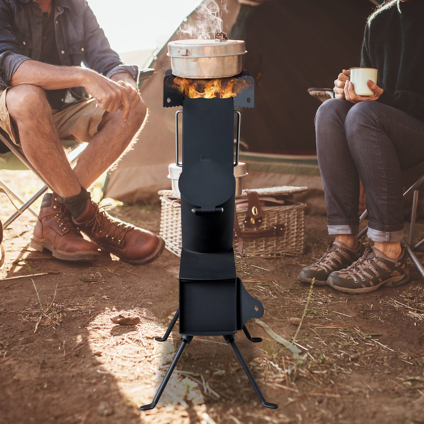 Two people sitting outdoors with a camping stove and pot, one holding a mug.