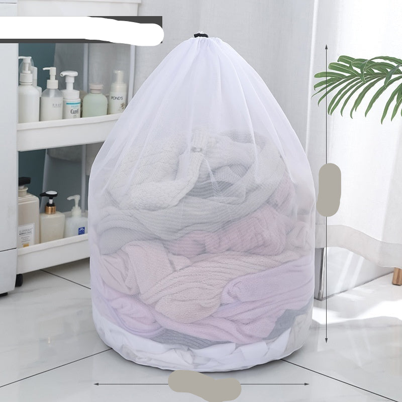 Two white mesh laundry bags filled with laundry standing in front of a washing machine with a person partially visible in the background.