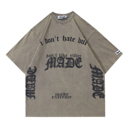 Beige t-shirt with black text and branding on a white background