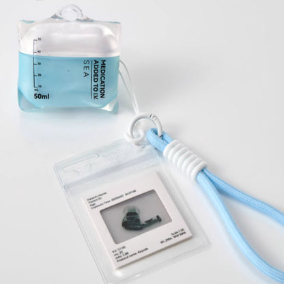 Medication adapter tool with a lanyard on a white background