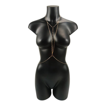 A gold-colored body chain displayed on a mannequin's torso.