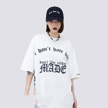Person wearing a white t-shirt with text and a black cap on a light gray background
